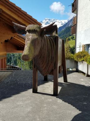 Bull made of water trough and many layers of one-inch-thick wood slabs for a neck ,is very thoughtful and still.