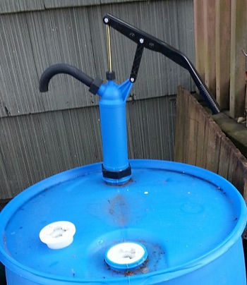 Plastic pump installed in water barrel.