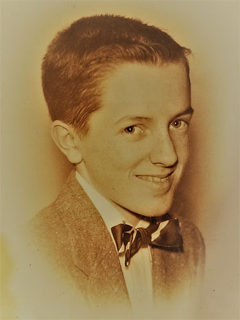 Al at fourteen years, dressed in suit and bow tie for eighth grade graduation. Sepia photo.