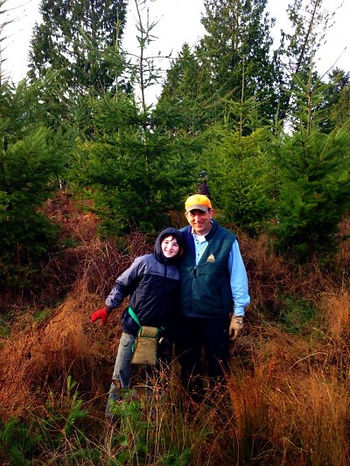 Woody and grandson in the grasses of our tree farm.