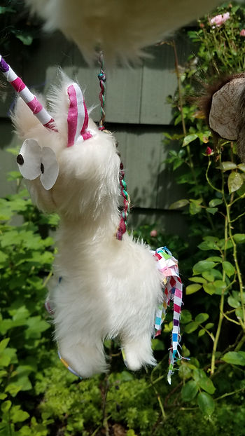 White unicorn with rainbow ears, tail and horn,