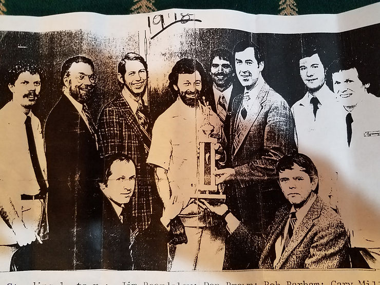 Ten adult friends who play basketball together showoff their trophy.  Al is kneeling on left side.