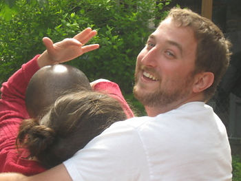 My three kids doing their hug by pretending not to want it, but not working too hard to get out of it.